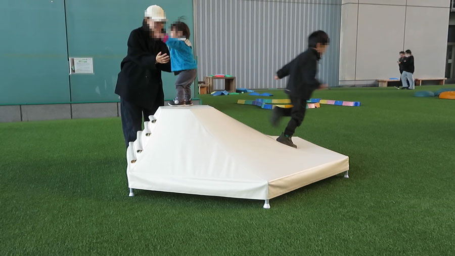 災害時の避難所を想定した大学との共同研究で開発中のテント膜製子ども用遊具を体験する幼児の様子②
